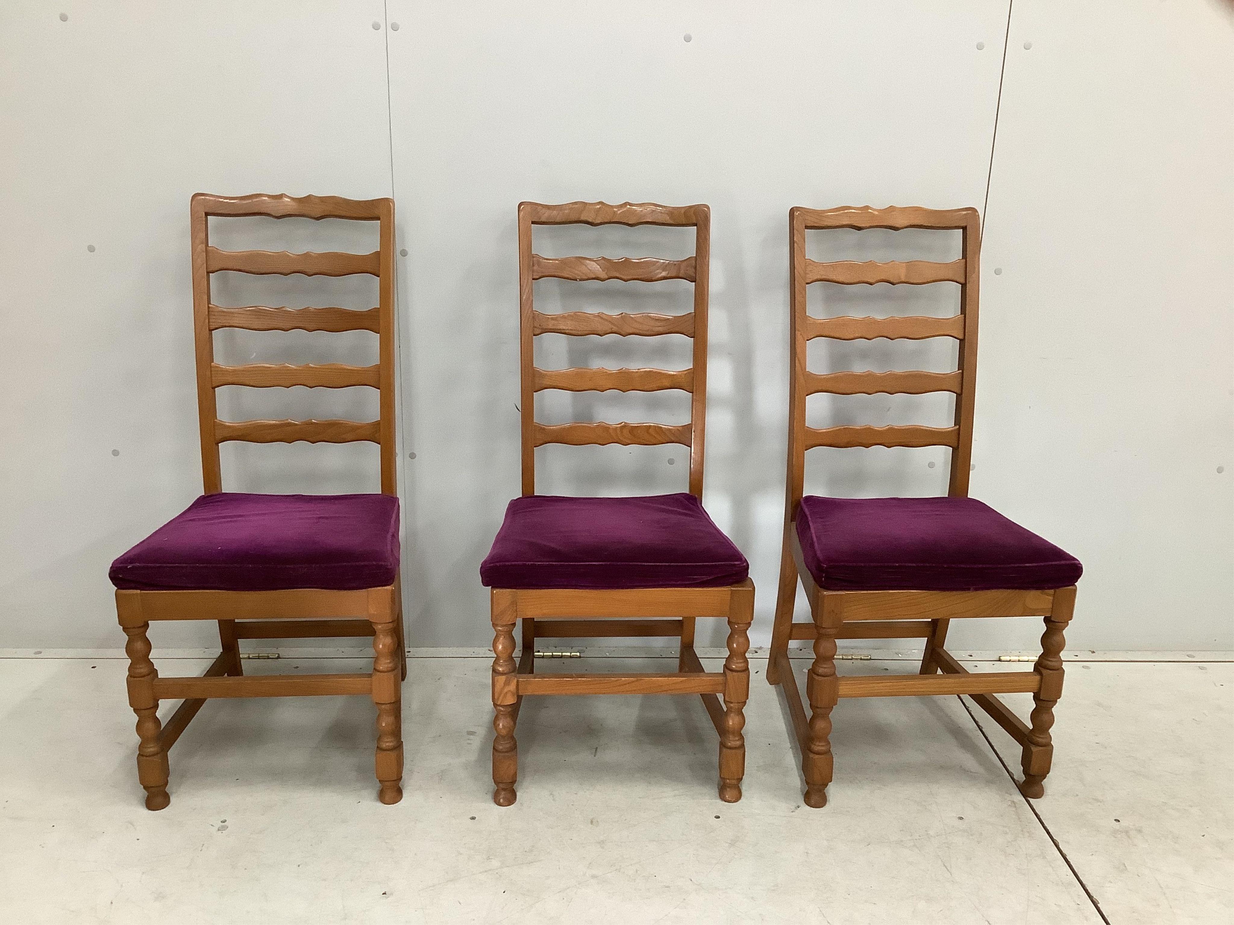 An Ercol Windsor elm dining suite comprising a sideboard, six ladderback dining chairs and extending dining table. Condition - fair to good
